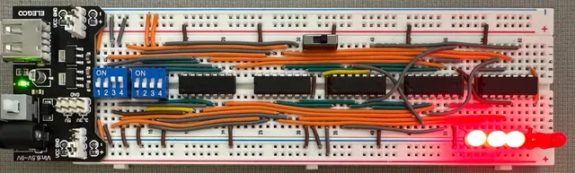 A 5-bit binary adder built from logic gates on a single breadboard.