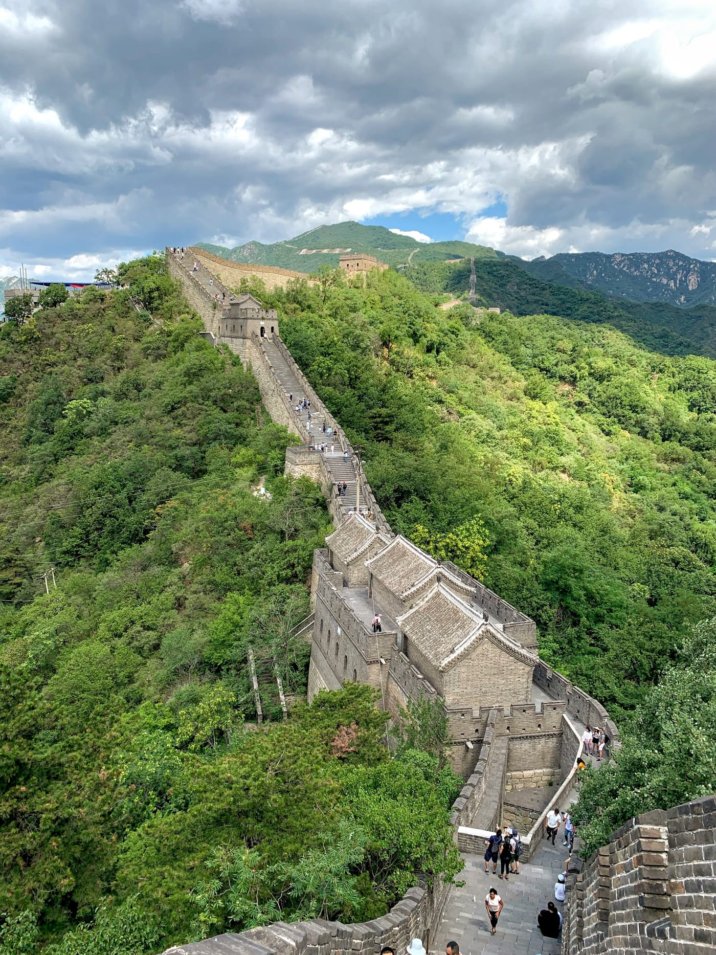 The Great Wall snaking over green ridges.
