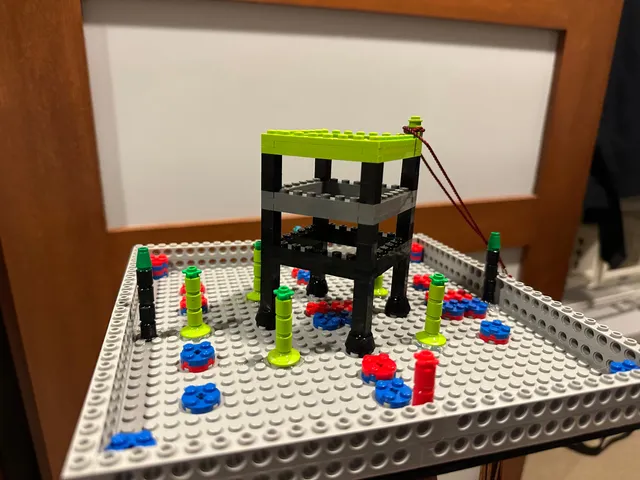 A graduation cap decorated as a miniature VEX robotics field.