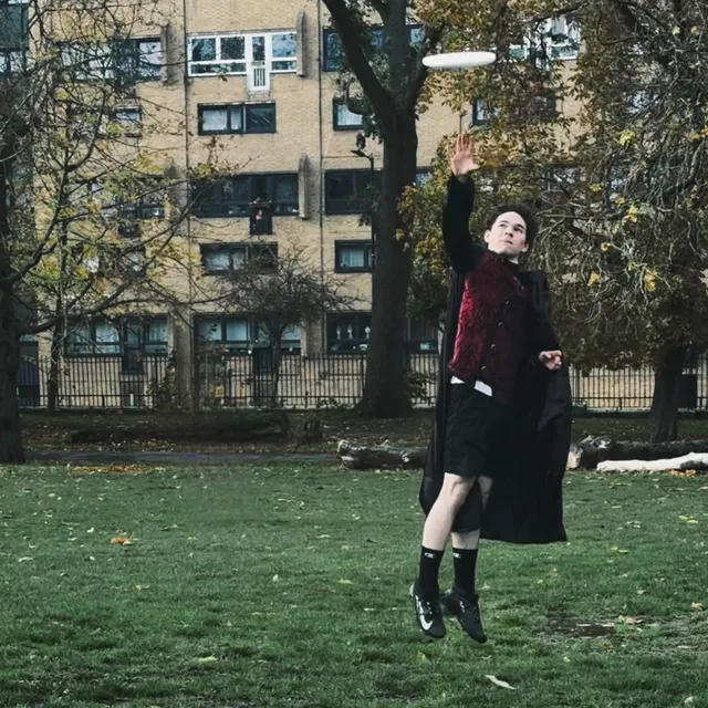 Kellan catching a disc dressed as the Phantom of the Opera.