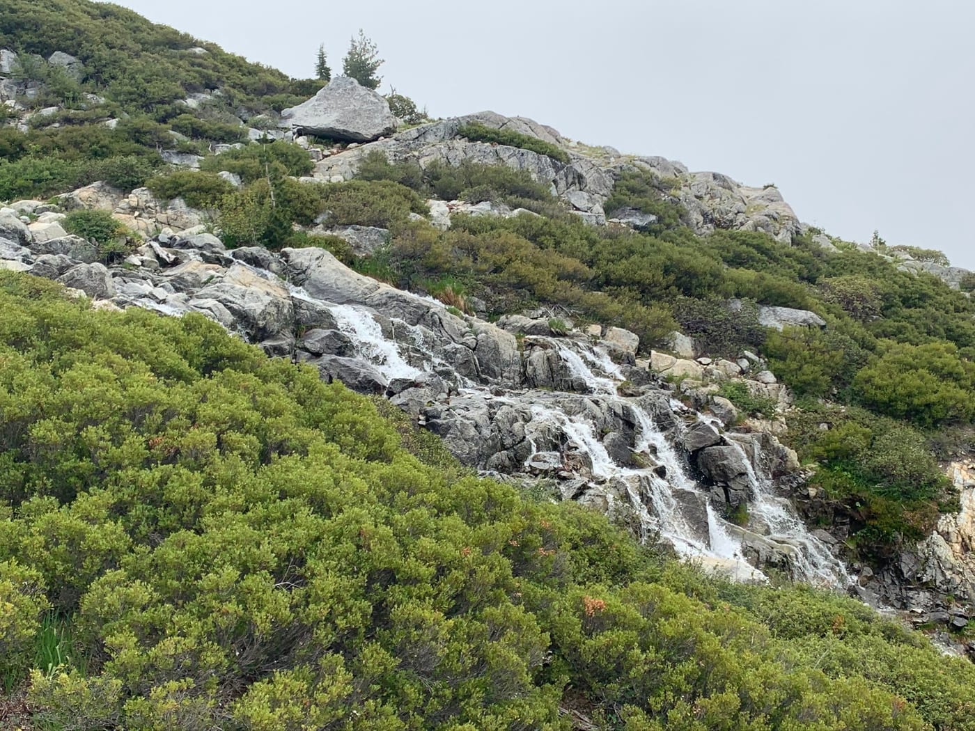 Whitewater threading down a rocky hillside.