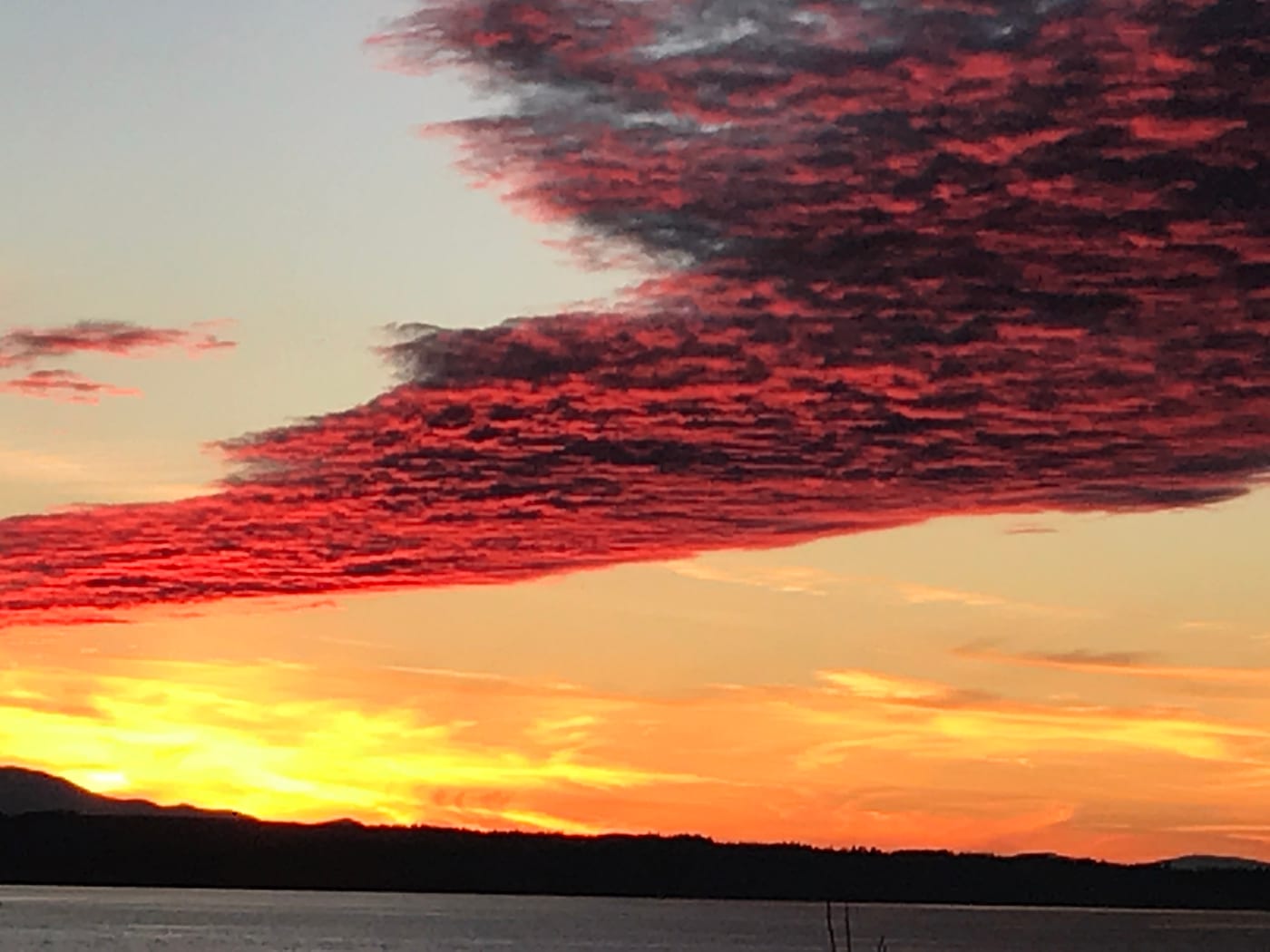 Red-streaked clouds over a darkening sound.