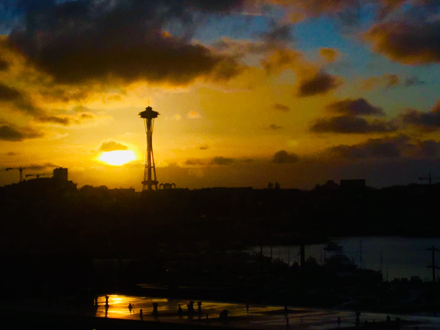 Space Needle silhouetted against an amber sunset.